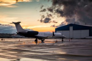 business-jet-sunset-after-rain-airport-apron-near-hangar